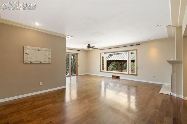 1303 Hermosa Way, Colorado Springs, CO 80906 - unfurnished living room with ceiling fan, baseboards, wood finished floors, crown molding, and recessed lighting