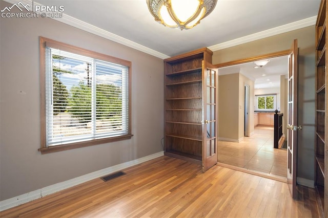 1303 Hermosa Way, Colorado Springs, CO 80906 - unfurnished room with french doors, baseboards, crown molding, and light wood-style flooring