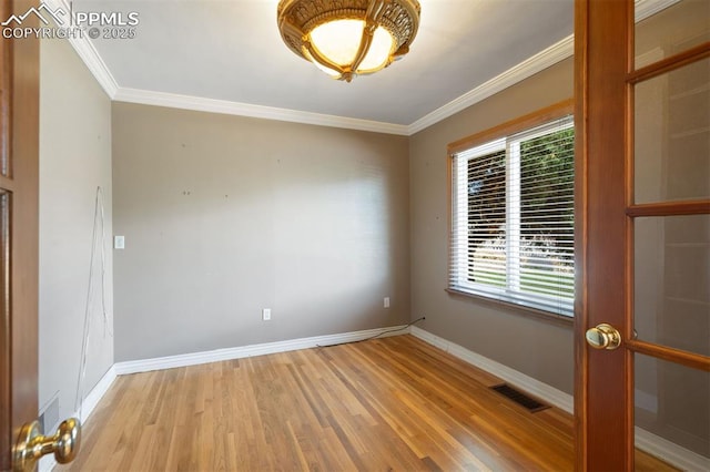 1303 Hermosa Way, Colorado Springs, CO 80906 - unfurnished room featuring light wood-style flooring, baseboards, and crown molding