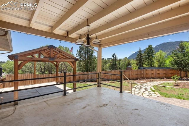 1303 Hermosa Way, Colorado Springs, CO 80906 - fenced backyard with a patio area, a gazebo, and a mountain view
