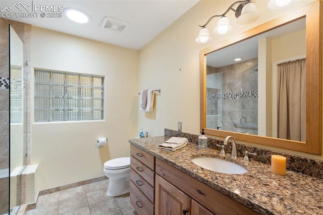 1303 Hermosa Way, Colorado Springs, CO 80906 - bathroom with a stall shower, vanity, toilet, baseboards, and tile patterned flooring