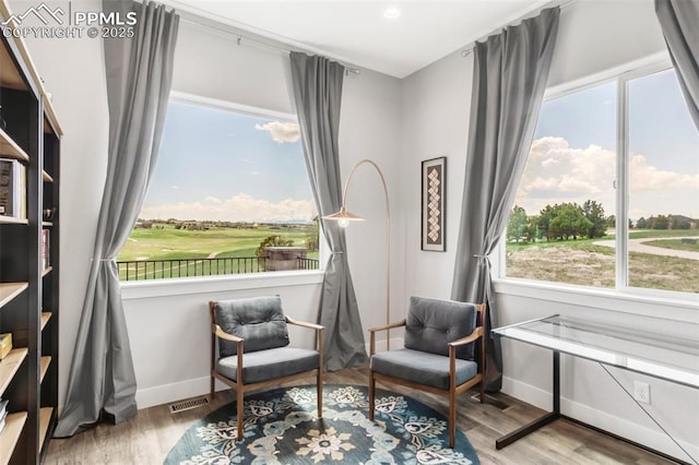 19887 Kershaw Ct, Monument, CO 80132 - sitting room with baseboards, wood finished floors, healthy amount of natural light, and view of golf course