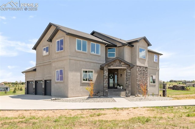 19887 Kershaw Ct, Monument, CO 80132 - view of front of home with a garage, stone siding, driveway, and stucco siding