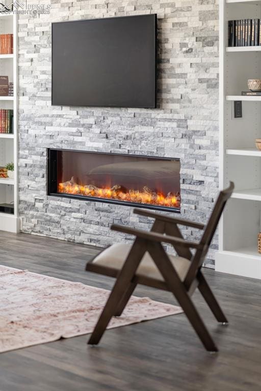 19887 Kershaw Ct, Monument, CO 80132 - detailed view of a stone fireplace, wood finished floors, and built in shelves