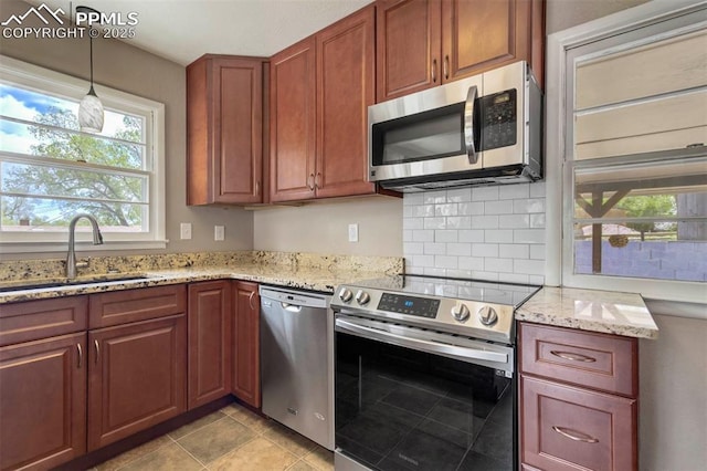 717 W Monroe St, Colorado Springs, CO 80907 - kitchen with appliances with stainless steel finishes, a sink, plenty of natural light, and light stone counters