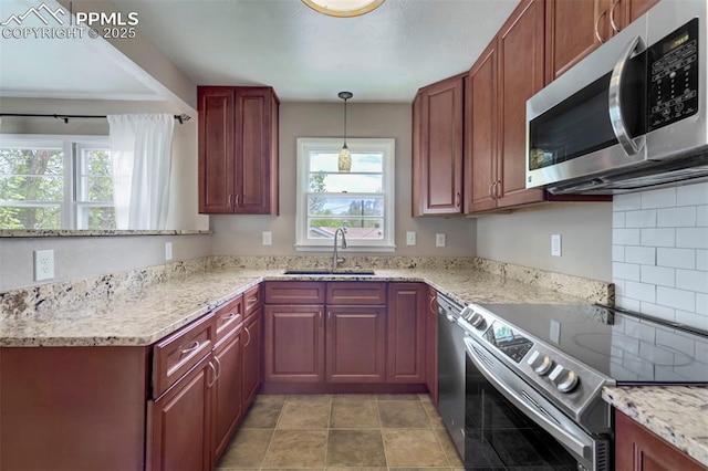 717 W Monroe St, Colorado Springs, CO 80907 - kitchen with appliances with stainless steel finishes, a sink, plenty of natural light, and light stone countertops