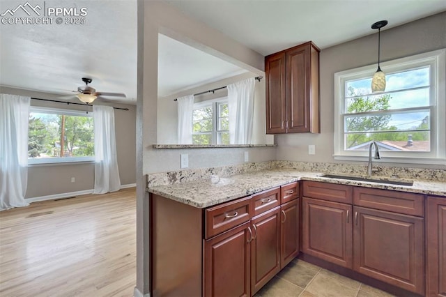 717 W Monroe St, Colorado Springs, CO 80907 - kitchen with a sink, plenty of natural light, ceiling fan, and light stone counters