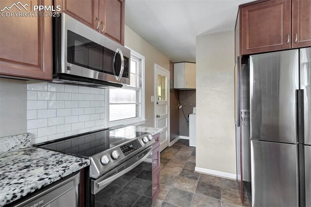717 W Monroe St, Colorado Springs, CO 80907 - kitchen with stainless steel appliances, tasteful backsplash, baseboards, and light stone countertops