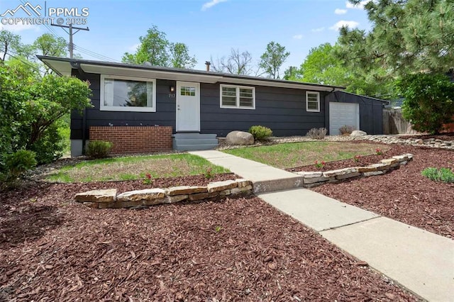 717 W Monroe St, Colorado Springs, CO 80907 - view of front of home featuring a garage and entry steps