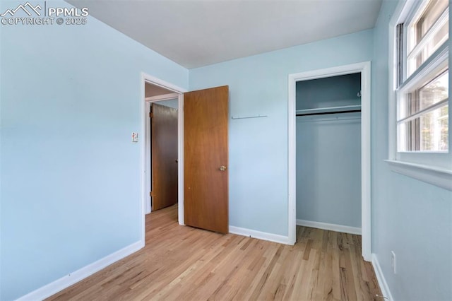 717 W Monroe St, Colorado Springs, CO 80907 - unfurnished bedroom with light wood-type flooring, baseboards, and a closet
