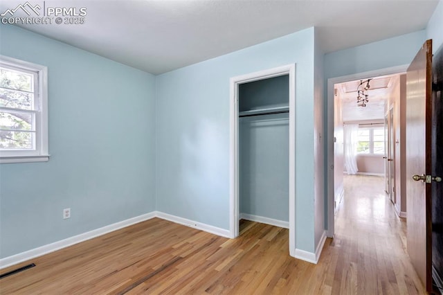 717 W Monroe St, Colorado Springs, CO 80907 - unfurnished bedroom with light wood-style floors, baseboards, and a closet