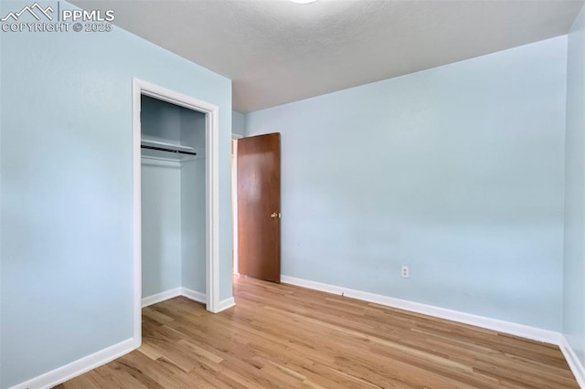 717 W Monroe St, Colorado Springs, CO 80907 - unfurnished bedroom with light wood-type flooring, baseboards, and a closet