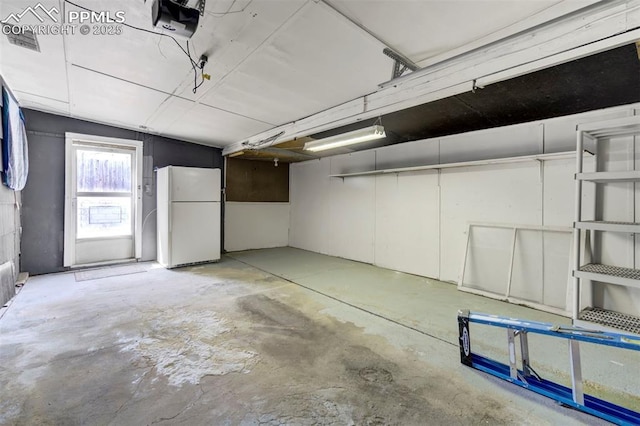717 W Monroe St, Colorado Springs, CO 80907 - garage featuring freestanding refrigerator and a garage door opener