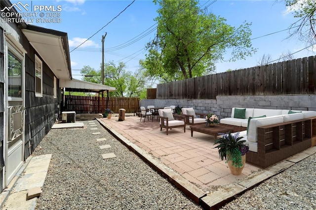 717 W Monroe St, Colorado Springs, CO 80907 - view of patio with an outdoor living space, a fenced backyard, and central AC unit