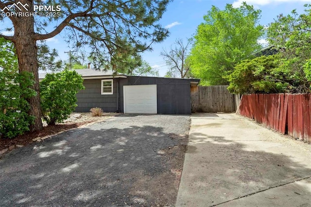 717 W Monroe St, Colorado Springs, CO 80907 - garage featuring fence and driveway