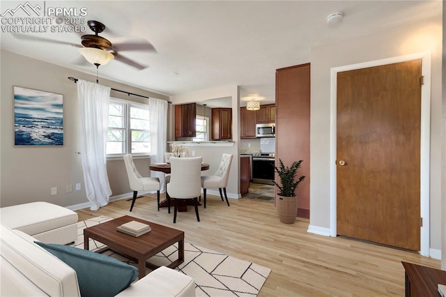 717 W Monroe St, Colorado Springs, CO 80907 - living room featuring light wood-style floors, baseboards, and a ceiling fan