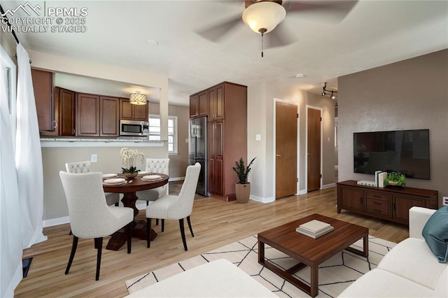 717 W Monroe St, Colorado Springs, CO 80907 - living room featuring light wood-style flooring, a ceiling fan, and baseboards