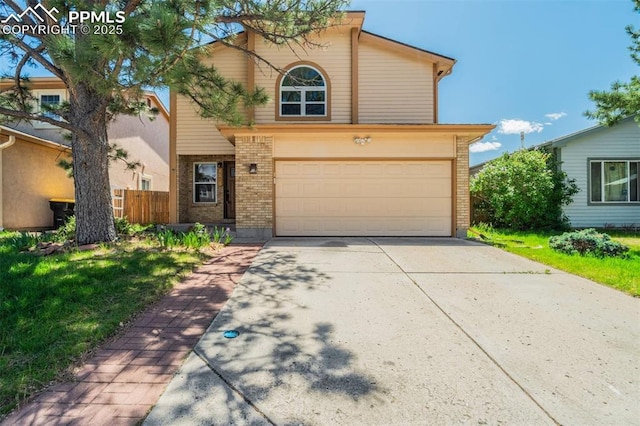 1559 Sausalito Dr, Colorado Springs, CO 80907 - traditional-style home featuring brick siding, an attached garage, and driveway