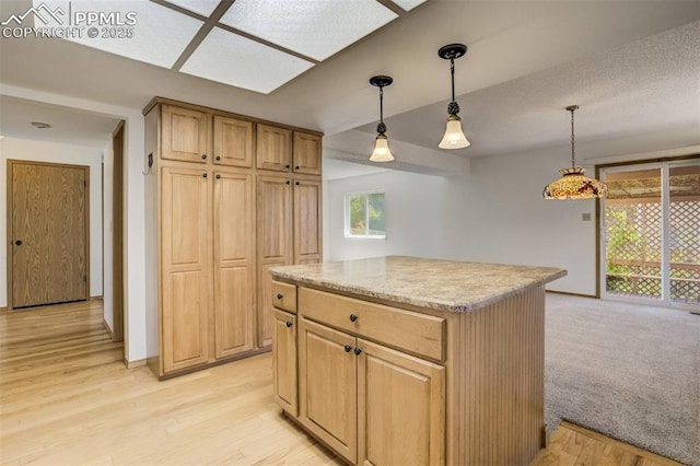 1559 Sausalito Dr, Colorado Springs, CO 80907 - kitchen with decorative light fixtures, a center island, and light wood-style flooring