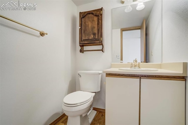 1559 Sausalito Dr, Colorado Springs, CO 80907 - half bathroom with toilet, vanity, and wood finished floors