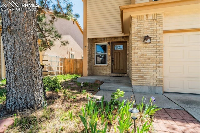 1559 Sausalito Dr, Colorado Springs, CO 80907 - entrance to property featuring brick siding and an attached garage