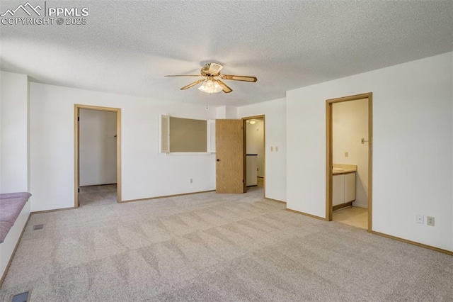 1559 Sausalito Dr, Colorado Springs, CO 80907 - unfurnished bedroom with carpet flooring, a spacious closet, ensuite bathroom, baseboards, and a textured ceiling