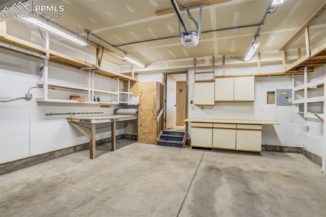 1559 Sausalito Dr, Colorado Springs, CO 80907 - garage with electric panel, a garage door opener, and baseboards