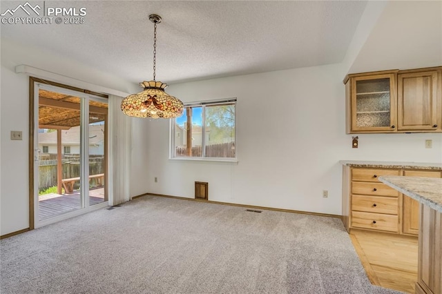 1559 Sausalito Dr, Colorado Springs, CO 80907 - unfurnished dining area featuring a textured ceiling, baseboards, and light carpet