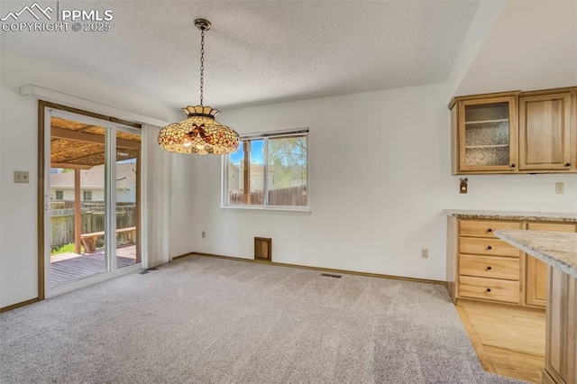 1559 Sausalito Dr, Colorado Springs, CO 80907 - unfurnished dining area featuring a textured ceiling, light carpet, and baseboards
