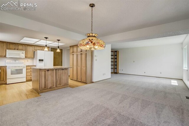 1559 Sausalito Dr, Colorado Springs, CO 80907 - kitchen with white appliances, light colored carpet, open floor plan, light countertops, and decorative light fixtures