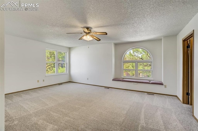 1559 Sausalito Dr, Colorado Springs, CO 80907 - carpeted empty room with healthy amount of natural light, a ceiling fan, a textured ceiling, and baseboards