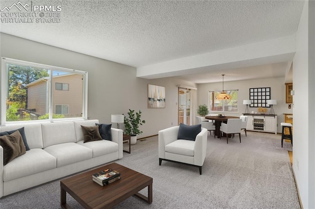 1559 Sausalito Dr, Colorado Springs, CO 80907 - living room featuring light colored carpet, a textured ceiling, and baseboards