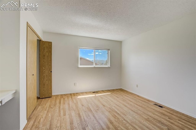 1559 Sausalito Dr, Colorado Springs, CO 80907 - unfurnished room featuring light wood-type flooring, a textured ceiling, and baseboards