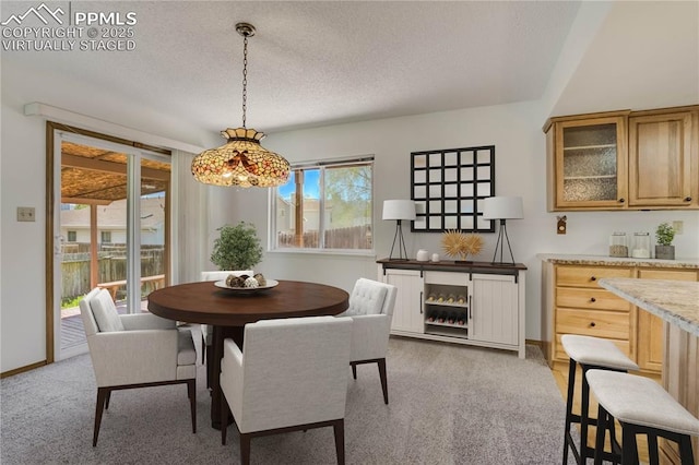 1559 Sausalito Dr, Colorado Springs, CO 80907 - carpeted dining room featuring a textured ceiling and baseboards