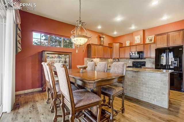8396 Snow Cap Vw, Colorado Springs, CO 80920 - dining room with light wood finished floors, recessed lighting, and baseboards