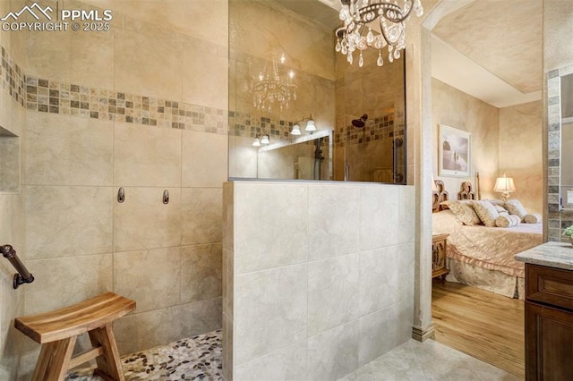 8396 Snow Cap Vw, Colorado Springs, CO 80920 - bathroom with a chandelier, walk in shower, ensuite bathroom, vanity, and tile patterned floors