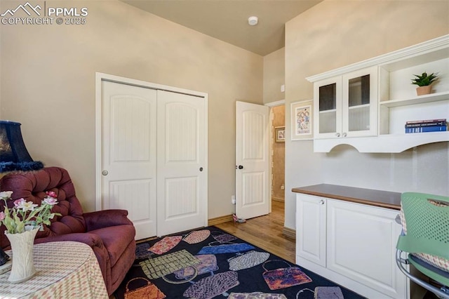 8396 Snow Cap Vw, Colorado Springs, CO 80920 - living area with light wood-style floors, a towering ceiling, and baseboards