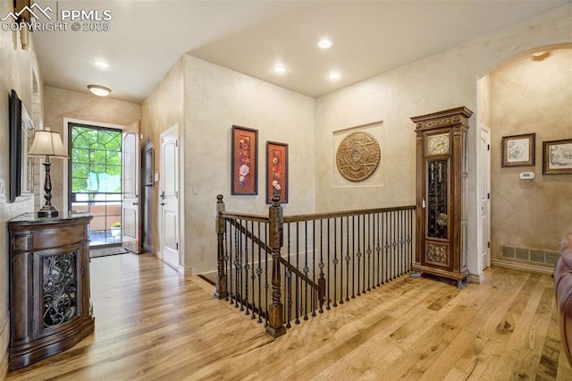 8396 Snow Cap Vw, Colorado Springs, CO 80920 - corridor featuring hardwood / wood-style flooring, an upstairs landing, arched walkways, and recessed lighting