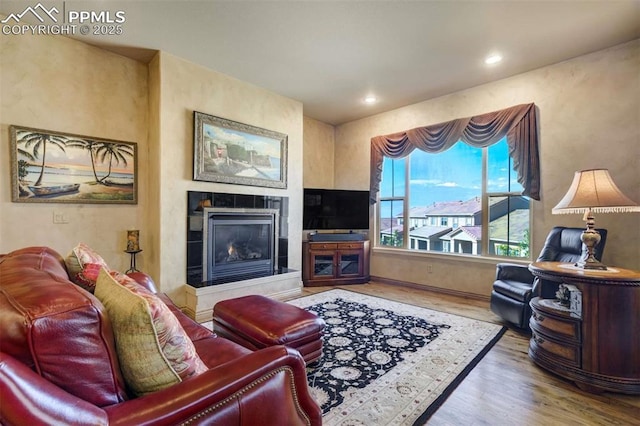 8396 Snow Cap Vw, Colorado Springs, CO 80920 - living area featuring a fireplace, wood finished floors, recessed lighting, and baseboards