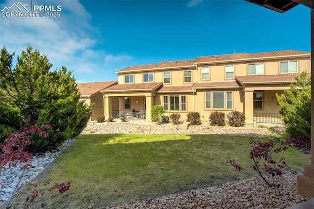 8396 Snow Cap Vw, Colorado Springs, CO 80920 - rear view of house featuring a porch, a yard, and stucco siding