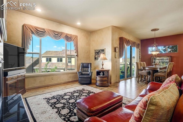 8396 Snow Cap Vw, Colorado Springs, CO 80920 - living room featuring plenty of natural light, wood finished floors, and recessed lighting