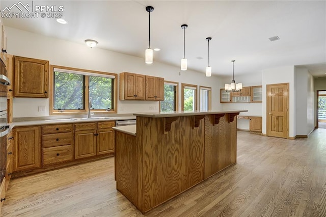 15635 Kingswood Dr, Colorado Springs, CO 80921 - kitchen featuring light wood-style flooring, a chandelier, brown cabinetry, and recessed lighting