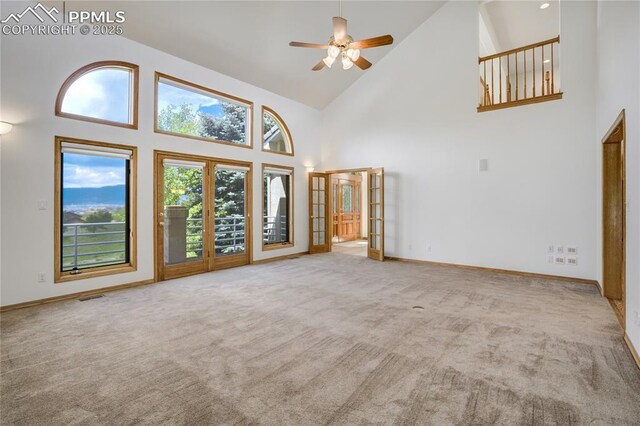 15635 Kingswood Dr, Colorado Springs, CO 80921 - unfurnished living room featuring high vaulted ceiling, a ceiling fan, carpet, and french doors