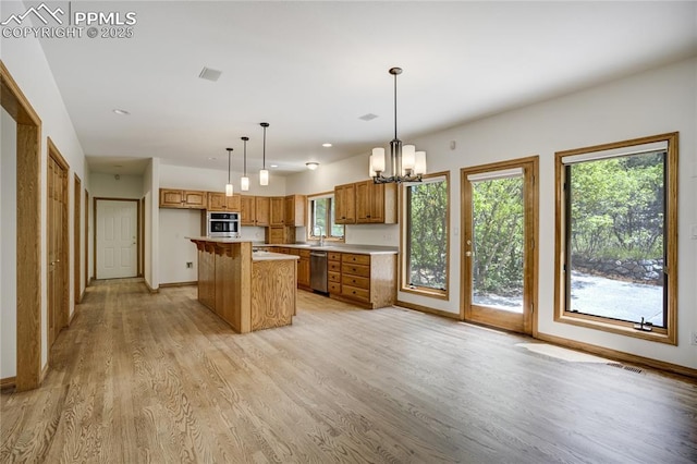 15635 Kingswood Dr, Colorado Springs, CO 80921 - kitchen featuring dishwasher, wall oven, light wood-style floors, a chandelier, and brown cabinets