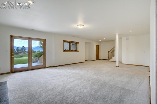 15635 Kingswood Dr, Colorado Springs, CO 80921 - unfurnished living room with light carpet, stairs, and recessed lighting