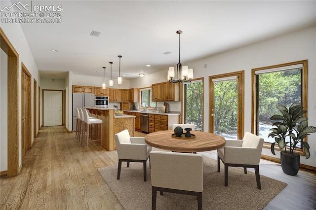 15635 Kingswood Dr, Colorado Springs, CO 80921 - dining area featuring light wood finished floors, a chandelier, and recessed lighting
