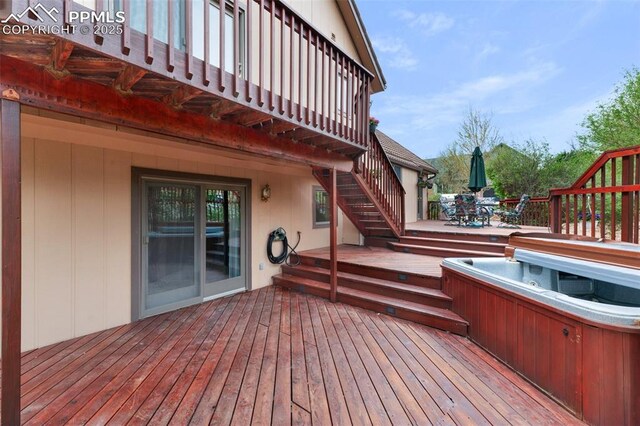 870 N Grey Eagle Cir, Colorado Springs, CO 80919 - deck featuring a covered hot tub, outdoor dining area, and stairway