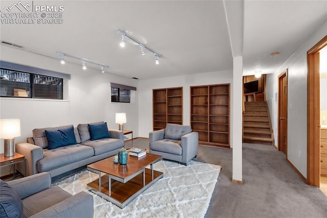 870 N Grey Eagle Cir, Colorado Springs, CO 80919 - living area with stairway, carpet floors, baseboards, and built in features