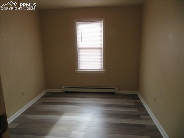 2354 E San Rafael St, Colorado Springs, CO 80909 - unfurnished room with a baseboard radiator, wood finished floors, and baseboards