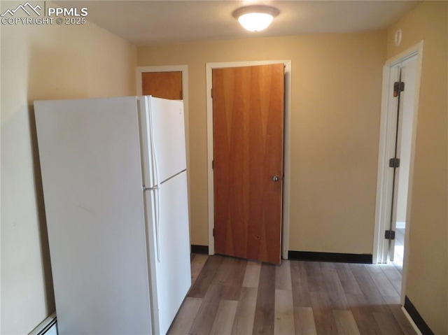 2354 E San Rafael St, Colorado Springs, CO 80909 - kitchen featuring freestanding refrigerator, light wood-type flooring, and baseboard heating